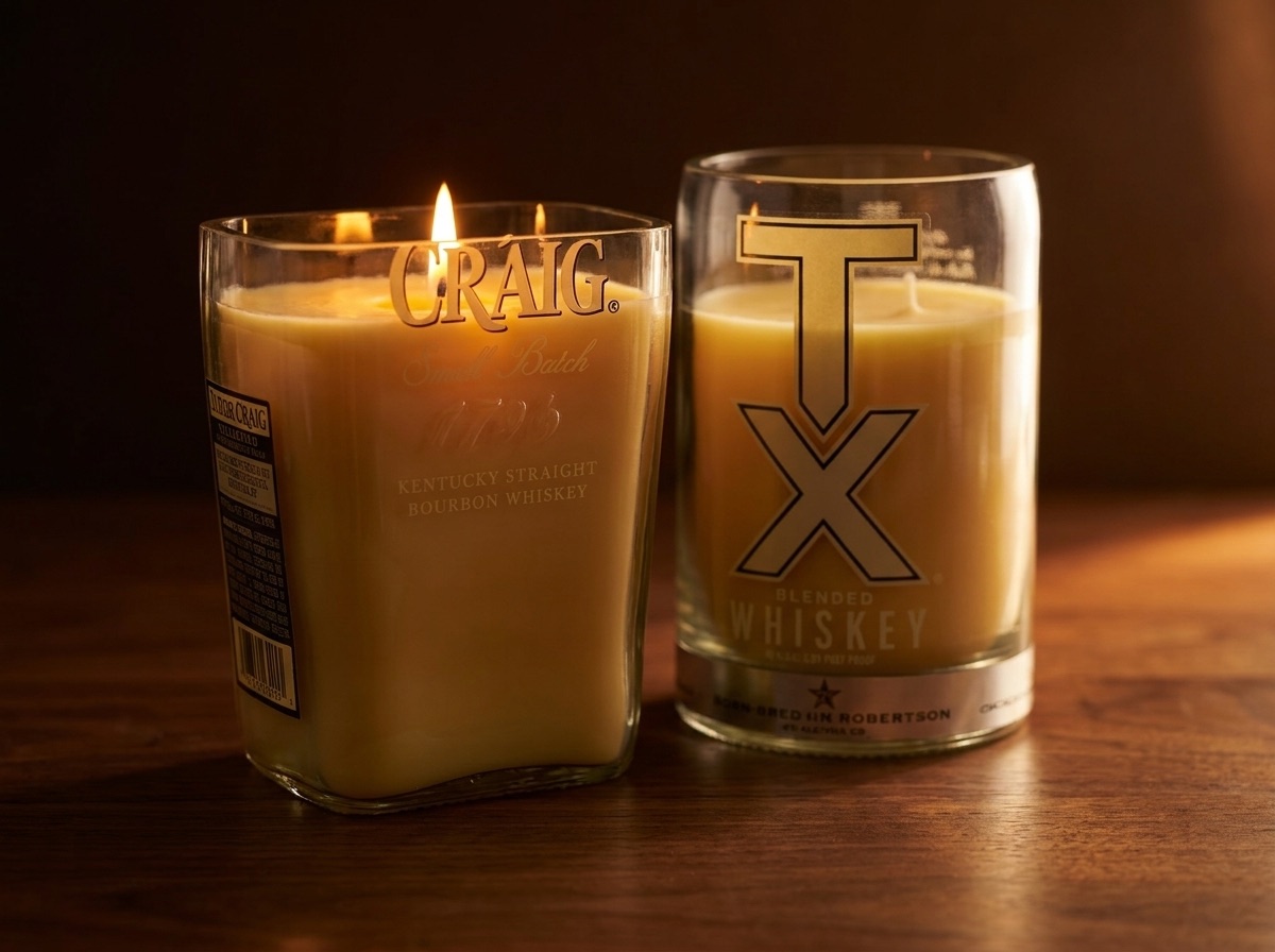 Two lit candles in cut recycled bottles